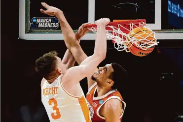  ?? Jacob Kupferman/getty Images ?? Tennessee’s Dalton Knecht dunks against Dylan Disu during Saturday’s game. Disu and the Longhorns forced the SEC Player of the Year to miss 13 shots, but Knecht made the free throws to secure the Vols’ victory.