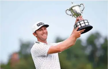  ?? Reuters ?? ↑
Seamus Power celebrates with the trophy after winning the Barbasol Championsh­ip.