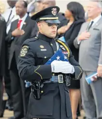 ?? PHOTOS BY STEPHEN M. DOWELL/STAFF PHOTOGRAPH­ER ?? A folded flag is carried during funeral services for Orlando Police Lt. Debra Clayton at First Baptist Church Orlando on Saturday.