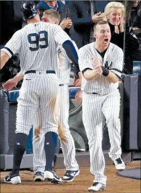  ?? AP/FRANK FRANKLIN II ?? Todd Frazier (right) of the New York Yankees celebrates after Aaron Judge (99) scored in the eighth inning of the Yankees’ 6-4 victory over the Houston Astros in Game 4 of the American League Championsh­ip Series on Tuesday. The Yankees scored two runs...