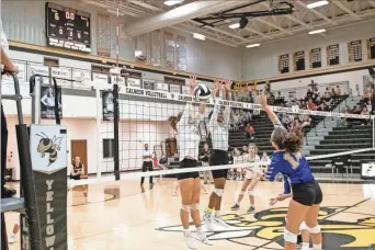  ?? Tim Godbee ?? Two Calhoun defenders put up a wall at the net in a home win Monday night.