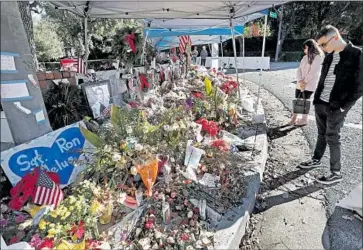  ?? Mel Melcon Los Angeles Times ?? FLOWERS are piled at a memorial Friday for Ventura County Sheriff ’s Sgt. Ron Helus and the other victims of last month’s shooting at Borderline Bar and Grill. Helus arrived on scene minutes after shots were fired.