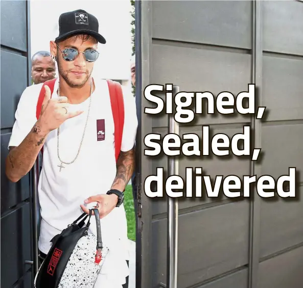  ??  ?? A new adventure: Brazilian forward Neymar gestures as he leaves his home in Barcelona for Paris yesterday. — AFP