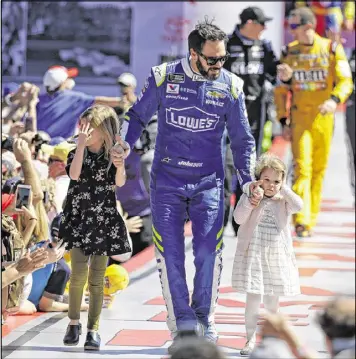  ?? JOHN RAOUX / ASSOCIATED PRESS ?? Jimmie Johnson, with his kids as he is introduced at last weekend’s Daytona 500, has shown he still has plenty left as he bids for his eighth title.
