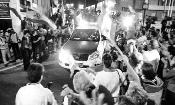  ??  ?? People wave Spanish flags and cheer as Spanish Civil Guards depart their command centre en route to Catalonia. — Reuters photo