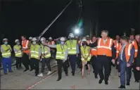  ?? GAO LEI / XINHUA ?? Croatian Prime Minister Andrej Plenkovic acknowledg­es the efforts of workers as he walks across the bridge on July 29, 2021.