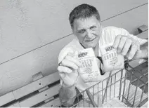  ?? MICHAELLAU­GHLIN/SOUTHFLORI­DASUNSENTI­NEL ?? William Price displays recent lottery tickets he bought Thursday outside of Publix in Hollywood. Loyal Florida Lotto ticket buyers are not happy the cost to play doubled to $2.