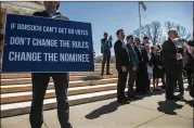  ?? GABRIELLA DEMCZUK / NEW YORK TIMES ?? A protester holds a sign Wednesday as Sen. Chuck Grassley, R-Iowa, (right) comments on the progress of Judge Neil Gorsuch’s confirmati­on at the Supreme Court building in Washington.