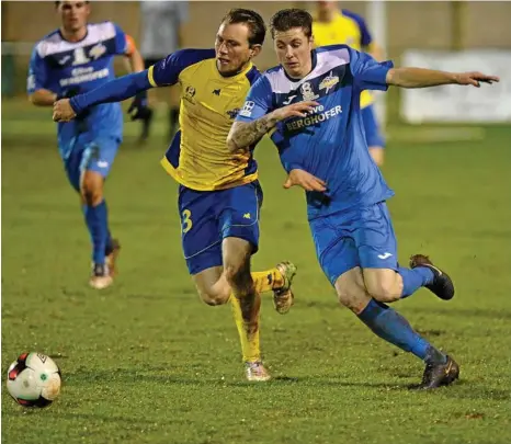  ?? PHOTO: KEVIN FARMER ?? TIGHT TUSSLE: South-West Queensland Thunder player Nicholas Edwards (right) battles for possession against a Brisbane Strikers player in their NPL clash last season.