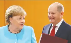  ?? FABRIZIO bensch / reuters / POOL FILES ?? Germany’s Chancellor Angela Merkel and Finance Minister Olaf Scholz plan to keep the fiscal taps open as their country rebounds from the pandemic shutdown.