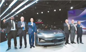  ?? EPA-Yonhap ?? GAC Motors executive team poses with the GAC Entranze at the North American Internatio­nal Auto Show at Cobo Center in Detroit, Mich., U.S., Monday.
