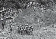  ?? Aaron Favila / Associated Press ?? Rescuers retrieve a body recovered Monday at the site where storm victims are believed to have been buried by a landslide caused by Typhoon Mangkhut.