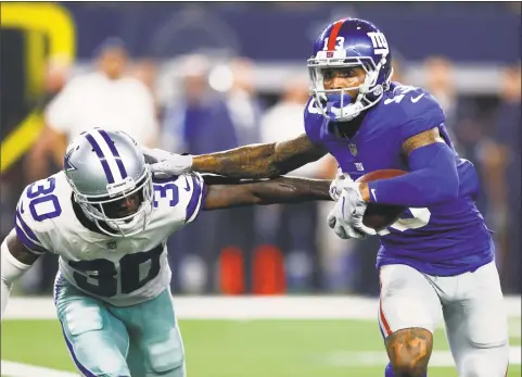  ?? Jim Cowsert / TNS ?? New York Giants wide receiver Odell Beckham runs against Dallas Cowboys cornerback Anthony Brown during the second half of Sunday night’s game.