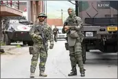  ?? BOJAN SLAVKOVIC / AP ?? German KFOR soldiers guard municipal building after Monday’s clashes between ethnic Serbs and troops from the NATO-led KFOR peacekeepi­ng force, in the town of Zvecan, northern Kosovo, Tuesday.