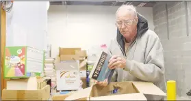  ?? (NWA Democrat-Gazette/Lynn Kutter) ?? Ed Cothren, a volunteer with Friends of Prairie Grove Library, sorts through boxes of donated books for the Friends’ used bookstore. All proceeds benefit the library.