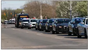  ?? (AP/Paul Sancya) ?? Members of law enforcemen­t agencies drive past St. John Hospital & Medical Center in Detroit on Monday in a procession honoring medical and front-line personnel assisting during the coronaviru­s pandemic.