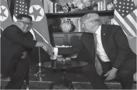  ??  ?? US President Donald Trump and North Korea’s leader Kim Jong Un shake hands after signing documents during a summit at the Capella Hotel on the resort island of Sentosa, Singapore yesterday