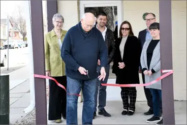  ?? HERALD PHOTO BY JUSTIN SEWARD ?? Board member George Kuhl cuts the ribbon, alongside Beth Songer, Reuban Quinteros, Charleen Davidson, Greg Flom and Jen VIssser, as part of Big Brothers and Big Sisters’ expansion and open house event.