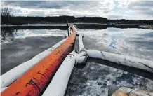  ?? ED KAISER/FILES ?? Oil glistens off the water as booms line a marsh near Canadian Natural Resources Ltd.’s Primrose oilsands project in an attempt to contain bitumen seeping to the surface in 2013.