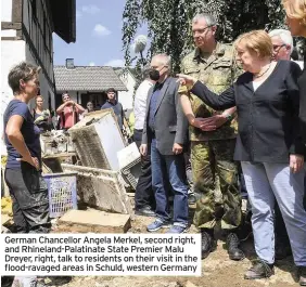  ??  ?? German Chancellor Angela Merkel, second right, and Rhineland-Palatinate State Premier Malu Dreyer, right, talk to residents on their visit in the flood-ravaged areas in Schuld, western Germany