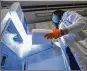  ?? ZSOLT CZEGLEDI / MTI ?? Vaccines are refrigerat­ed in Debrecen, Hungary, after the first batch of the Pfizer-BioNTech vaccines arrived in the country Saturday.