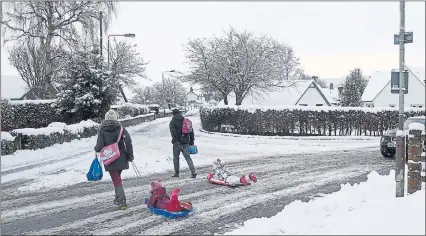  ??  ?? EASY STREET: These children, in Moulin, Perthshire, know how to make the most of the wintry conditions. Pictures: Russell Cheyne