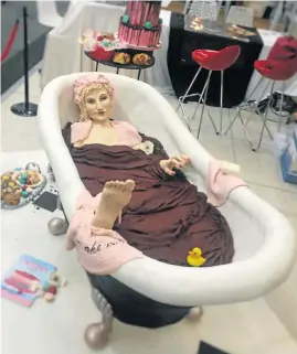  ??  ?? LET THEM EAT CAKE: Streetkids got a chance to tuck into this 300kg cake of Marie Antoinette in a bathtub, which took three weeks to create