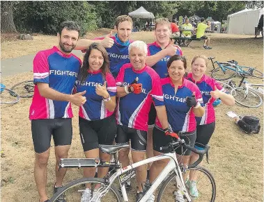  ??  ?? Ron Nalewajek, front centre, is flanked by his daughters Mara Nalewajek, left, and Gina Whitaker and surrounded by other members of their Fight4Fil cycling team.