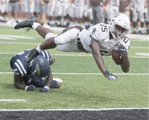  ?? ALLEN CUNNINGHAM/FOR THE SUN-TIMES ?? Mount Carmel running back Kyle Davis dives into the end zone for a touchdown during the first half Saturday in DeKalb.
