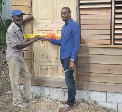  ?? CHRISTOPHE­R THOMAS PHOTOS ?? Jeremiah McFarlane, 88, receives the keys to his new house from Central Westmorela­nd Member of Parliament Dwayne Vaz. The house was constructe­d at a cost of $300,000 as part of the MP’s housing assistance programme in the constituen­cy.