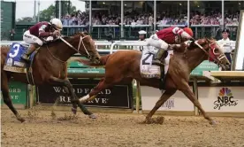  ?? ?? Rich Strike (21), with Sonny Leon aboard, beats Epicenter (3), with Joel Rosario aboard, at the finish line to win the 148th running of the Kentucky Derby. Photograph: Mark Humphrey/