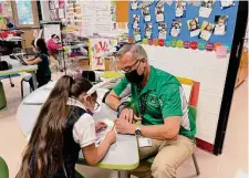  ?? ?? John Leos works with Luzila “Luz” Fonseca at Las Palmas Leadership School for Girls, where a love of learning is palpable.