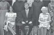  ?? JOHN STILLWELL/GETTY IMAGES ?? Duchess Meghan and Prince Harry, from left, spoke fondly of Queen Elizabeth II, right, during their Oprah Winfrey interview.