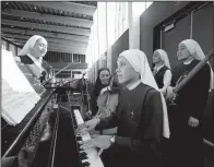  ?? AP/DAMIAN DOVARGANES ?? The Catholic nuns of the musical group Siervas say they aren’t rock stars despite playing at concerts where fans number in the thousands.