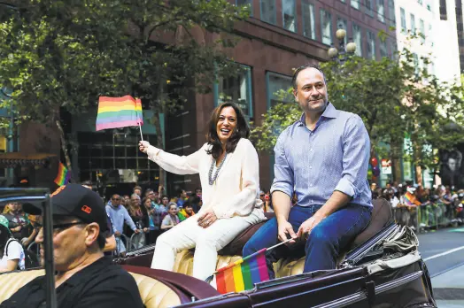  ?? Gabrielle Lurie / Special to The Chronicle 2016 ?? Thenstate Attorney General Kamala Harris rides with her husband in San Francisco’s LGBT Pride Parade in 2016.