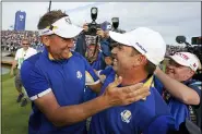  ?? LAURENT CIPRIANI — THE ASSOCIATED PRESS FILE ?? In this Sept. 30, 2018, file photo, Europe’s Sergio Garcia, right, celebrates with Ian Poulter after Europe won the Ryder Cup on the final day of the 42nd Ryder Cup at Le Golf National in Saint-Quentin-en-Yvelines, outside Paris, France. The pandemic-delayed 2020Ryder Cup returns the United States next week at Whistling Straits along the Wisconsin shores of Lake Michigan.