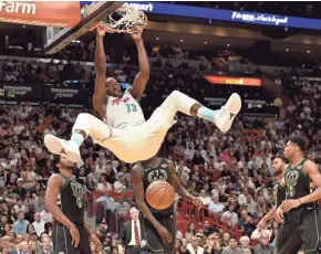  ?? STEVE MITCHELL / USA TODAY SPORTS ?? Heat center Bam Adebayo dunks in the second half against the Bucks. He finished with 15 points and 10 rebounds.