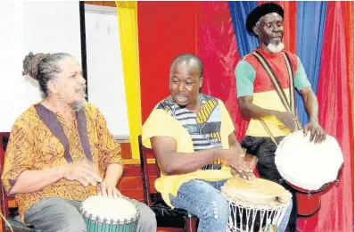  ?? PHOTOS BY MICHAEL RECKORD ?? Drummers (from left) Philip Supersad, Daniel ‘Trumpet’ Mills and Calvin Mitchell playing in tribute to the late Kamau Brathwaite.