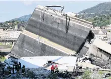  ?? PHOTO: REUTERS ?? Road ruined . . . Firefighte­rs and rescue workers stand next to the collapsed Morandi Bridge in the port city of Genoa.