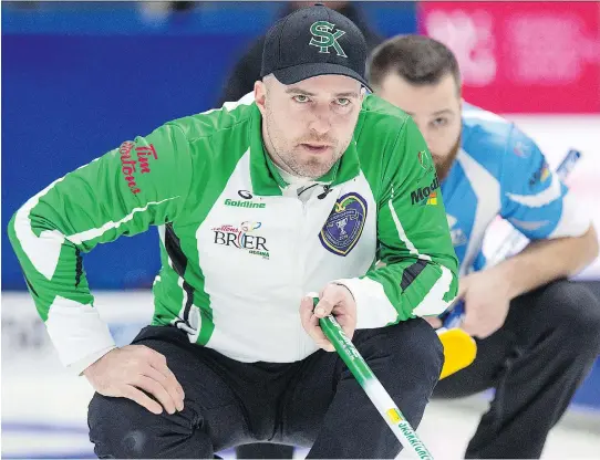  ?? ANDREW VAUGHAN/THE CANADIAN PRESS ?? Saskatchew­an skip Steve Laycock, left, and Quebec second William Dion watch a rock in their Brier match on Saturday in Regina. Quebec won 5-2.