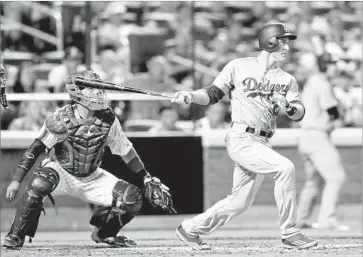  ?? Elsa Garrison Getty Images ?? CHASE UTLEY of the Dodgers hits a grand slam in the seventh inning against New York Mets reliever Hansel Robles as catcher Rene Rivera watches. Utley also hit a solo home run in the sixth inning.