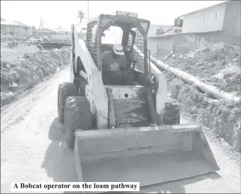  ?? ?? A Bobcat operator on the loam pathway