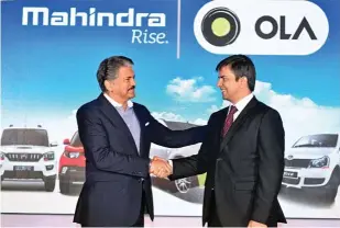  ??  ?? Anand Mahindra, Chairman, Mahindra Group, and Bhavish Aggarwal, Cofounder and CEO, Ola Cabs, at a strategic alliance announceme­nt.