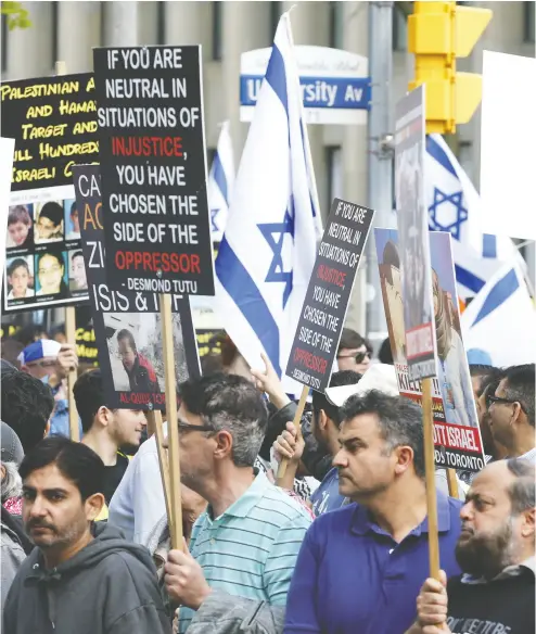  ?? JACK BOLAND / POSTMEDIA NEWS FILES ?? Participan­ts in an Al-quds Day rally in support of Palestinia­n rights encounter a group of pro-israel protesters in Toronto. Raheel Raza writes that these marches are antisemiti­c festivals of hate and contravene Islamic faith.