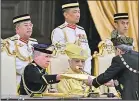  ?? Picture: REUTERS ?? Sultan of Johor, Sultan Ibrahim Iskandar receives documents during the oath taking ceremony as the 17th King of Malaysia at the National Palace in Kuala Lumpur.