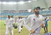  ?? — AFP ?? Pakistan skipper Misbah- ul- Haq leads the team off after winning the Test.