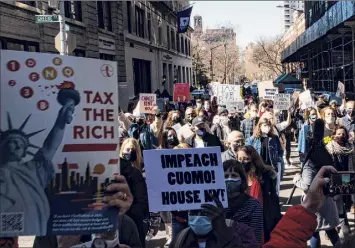  ?? Eduardo Munoz Alvarez / Associated Press ?? People attending a rally on March 20 in New York City call for the impeachmen­t of Gov. Andrew Cuomo. The governor faces multiple allegation­s that he sexually harassed or behaved inappropri­ately toward women who worked with him.