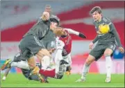  ??  ?? Arsenal's Alexandre Lacazette is tackled by Man United’s Harry Maguire during their Premier League match.