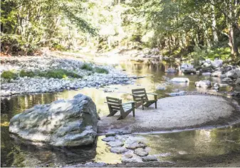  ??  ?? Wooden chairs along the Big Sur River encourage guests to stop and relax, read a book or enjoy a cup of coffee as they listen to the water glide along the rocks.