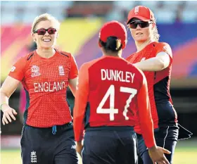  ??  ?? Warm-up: Sophia Dunkley celebrates a wicket with captain Heather Knight (left)